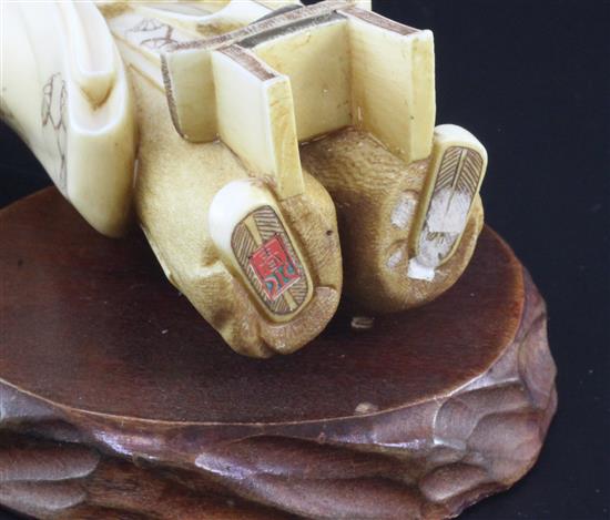 A Japanese ivory figure of a scholar, early 20th century, 11.8cm, wood stand